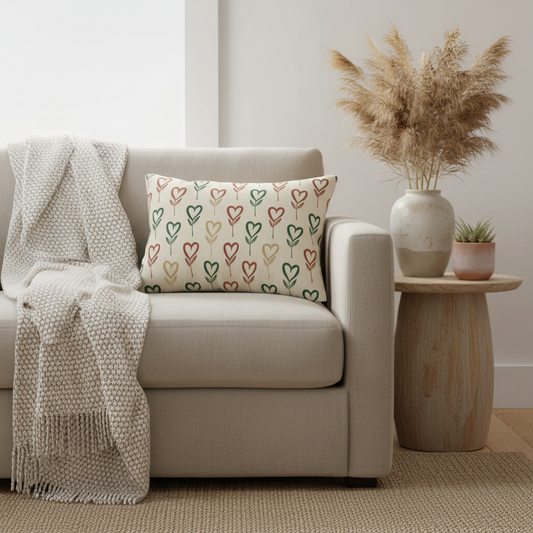 Heart stem decorative lumbar pillow styled on modern beige armchair in minimalist living room with dried pampas grass and neutral decor