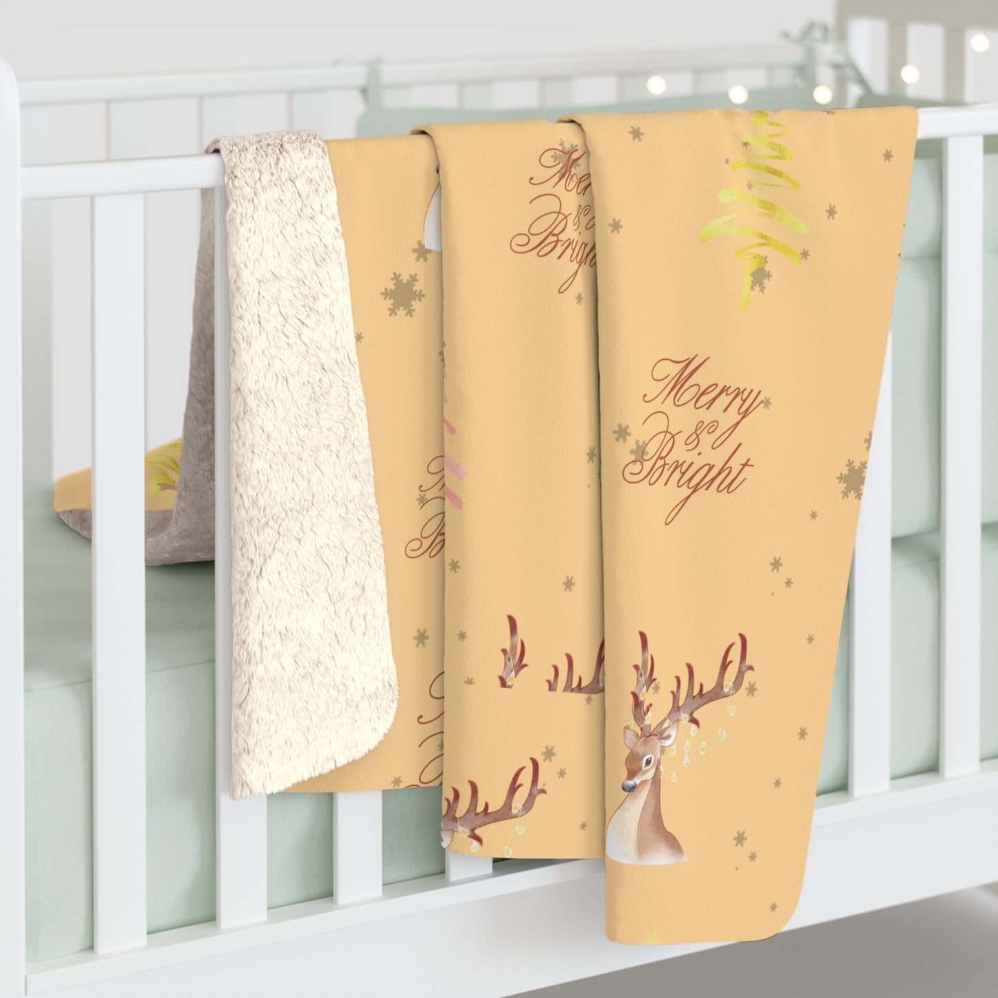 Three Christmas-themed blankets with reindeer and text on a white crib.