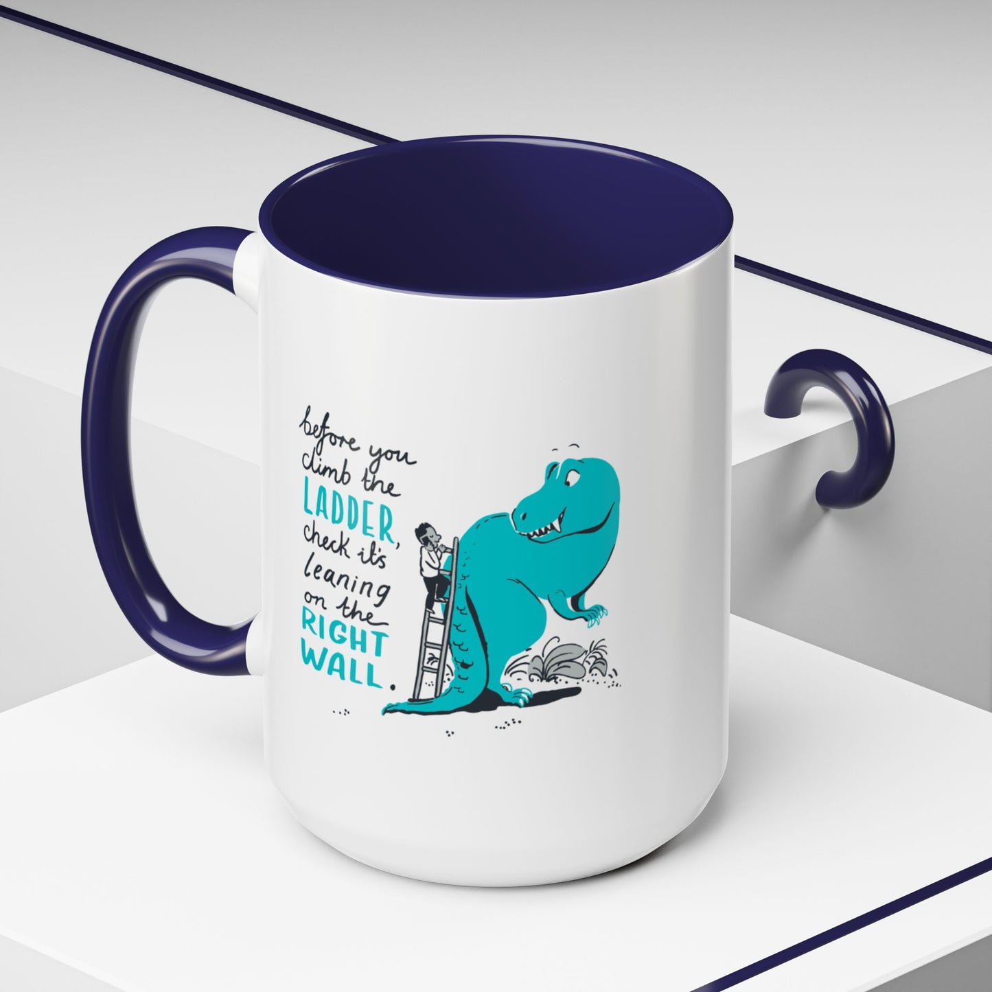 White mug with blue interior and handle, featuring a dinosaur graphic and text.