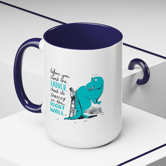 White mug with blue interior and handle, featuring a dinosaur graphic and text.