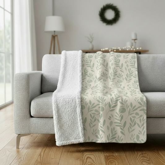 Botanical leaf pattern minky blanket draped on gray sofa
