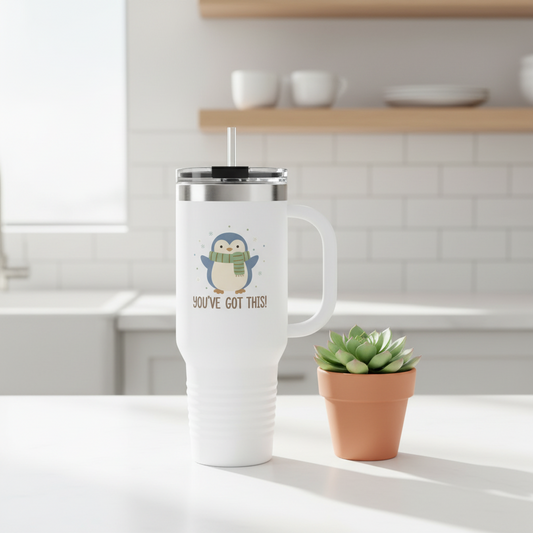 White 40oz insulated tumbler with cute penguin wearing scarf and You've Got This text on kitchen counter