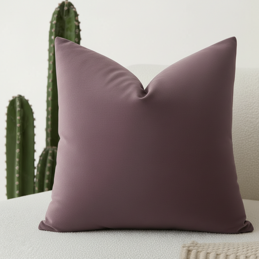 Textured purple throw pillow 26x26 with geometric pattern and zipper closure next to cactus plant