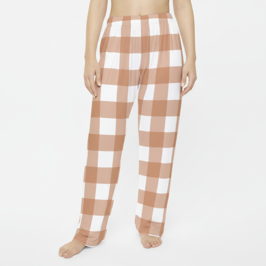 Woman wearing peach and white checkered gingham pajama pants - comfortable lounge wear for relaxing at home